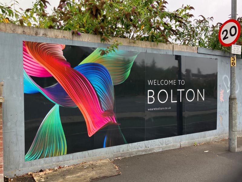 Print and installation of versatile dibond hoarding, incorporating large format ‘Welcome’ graphic and We Are Bolton’s brand visuals for Bolton Council by Impression’s experienced team.