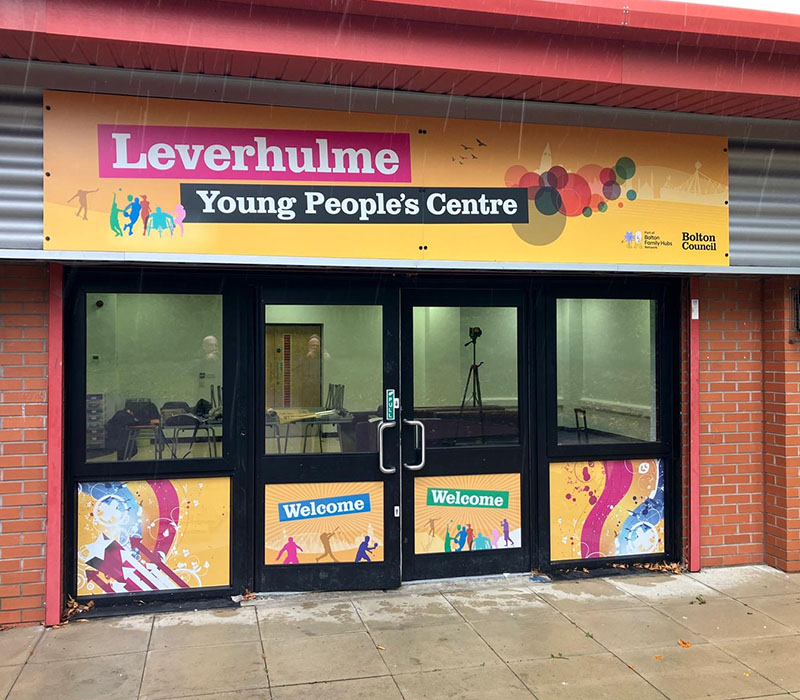 Branded front entrance external signage and vinyls welcoming visitors into Leverhulme Young People’s Centre