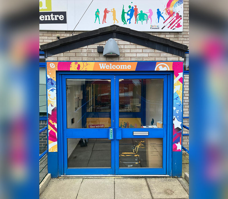 Branded and hardwearing external signage at the front entrance of Harwood’s Young People’s Centre in Bolton