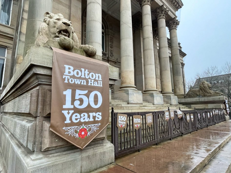 Bolton Town Hall dressed by Impression with large-format external graphics, designed and printed to celebrate 150th anniversary