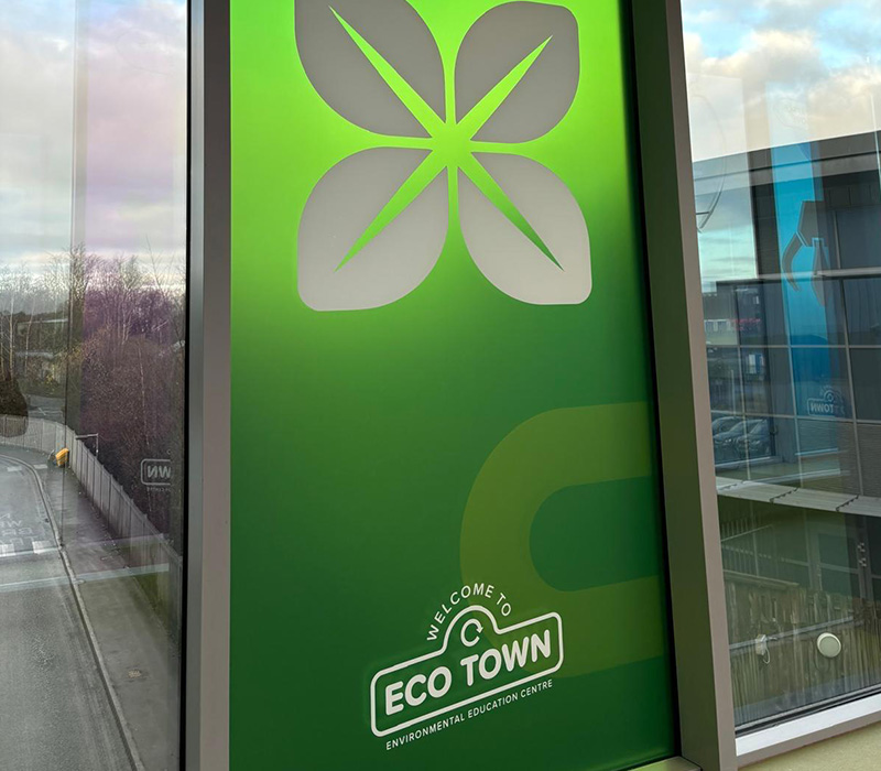 Colourful window vinyls, branded with Eco Town-themed colours and logos to engage visitors.