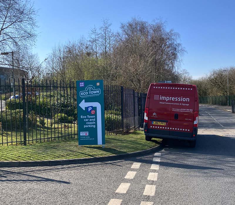 Impression’s installation van next to hardwearing outdoor wayfinding and directional signage