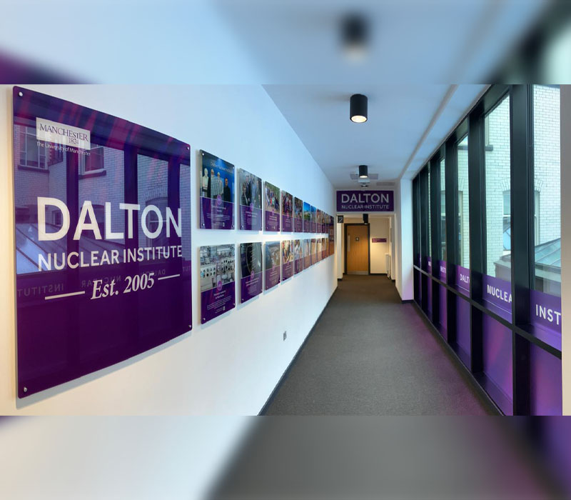 Purple internal corridor signage at the Dalton Nuclear Institute.