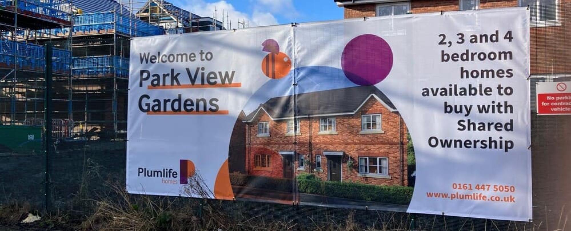 Construction site hoardings to promote Plumlife's new development in Manchester