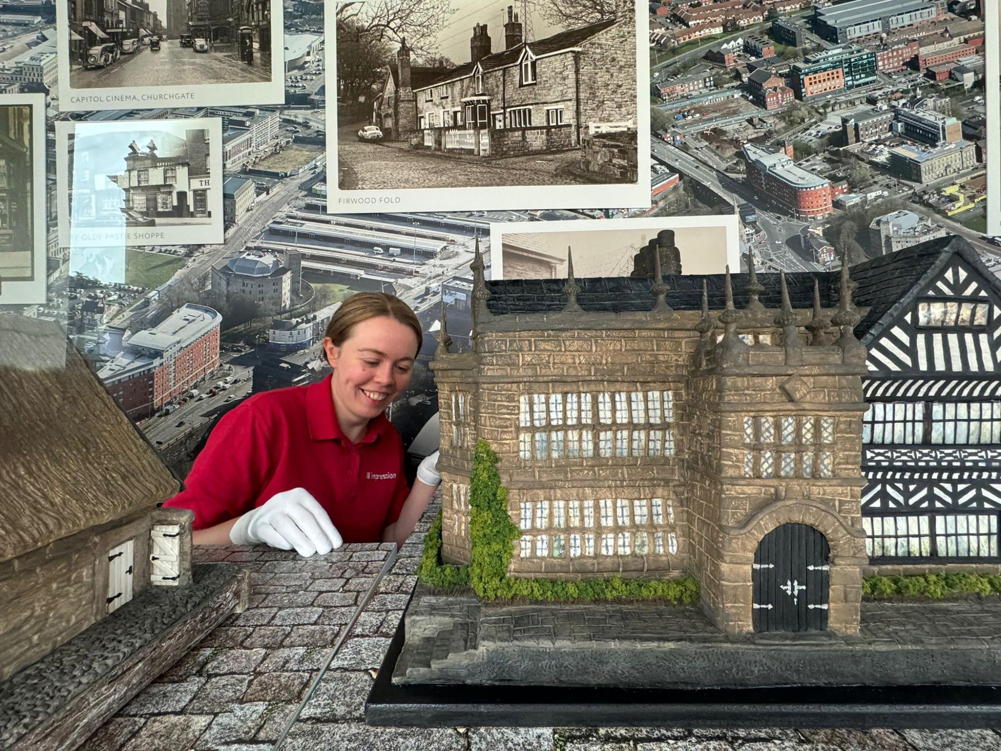 🏛️ Impression showcases new Bolton buildings artwork by local artist Verona Medhurst with unique display graphics & props