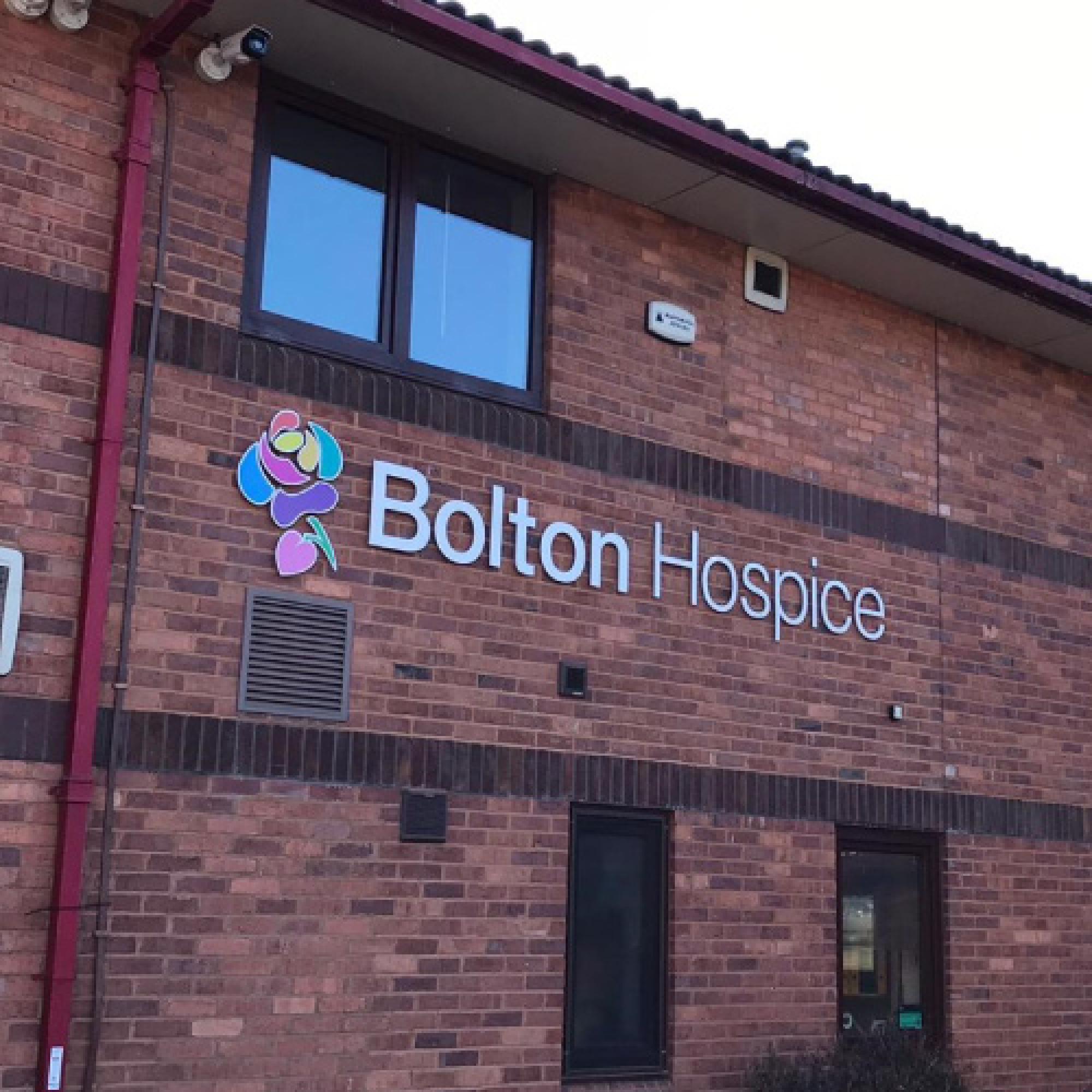 Branded external wall signage, featuring bespoke lettering and colourful brand icon