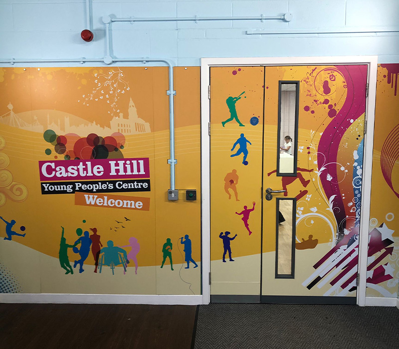 Internal wall and door with a large format graphic, created by Impression, to welcome people into Castle Hills Young Peoples Centres