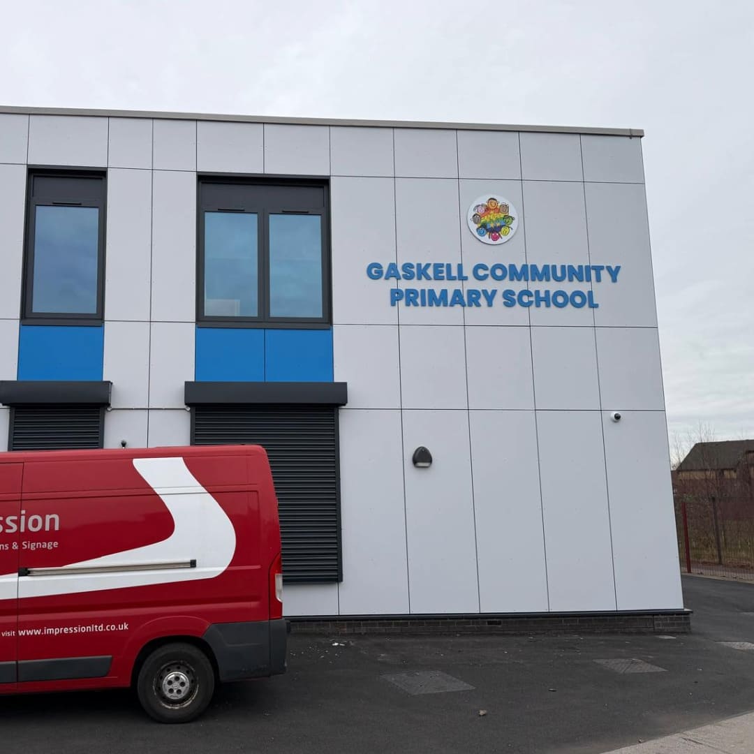 Impression van next to new letter signage installed on the exterior wall of Gaskell Community Primary School