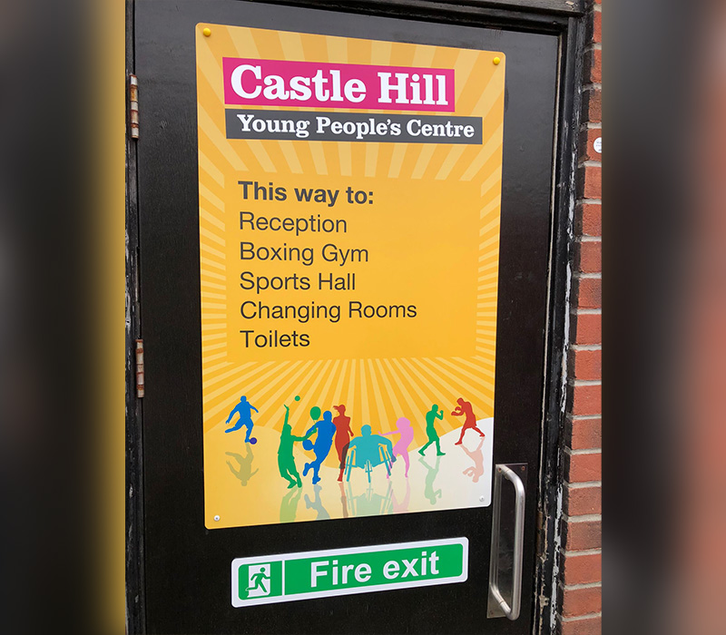 Castle Hills Young Peoples Centre branded door vinyl on the outside of the buildings fire exit door, also giving wayfinding options for other places around the Centre