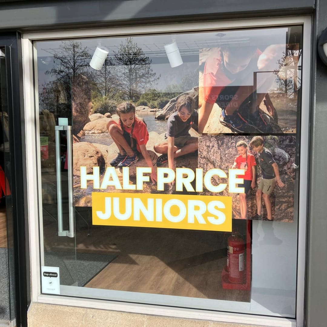 Regatta shopfront window display promoting half price on junior clothing