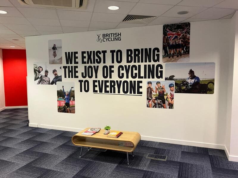 Striking branded wall graphics with large format images make an instant impact in this British Cycling office workspace in Manchester, printed in-house and installed by Impression